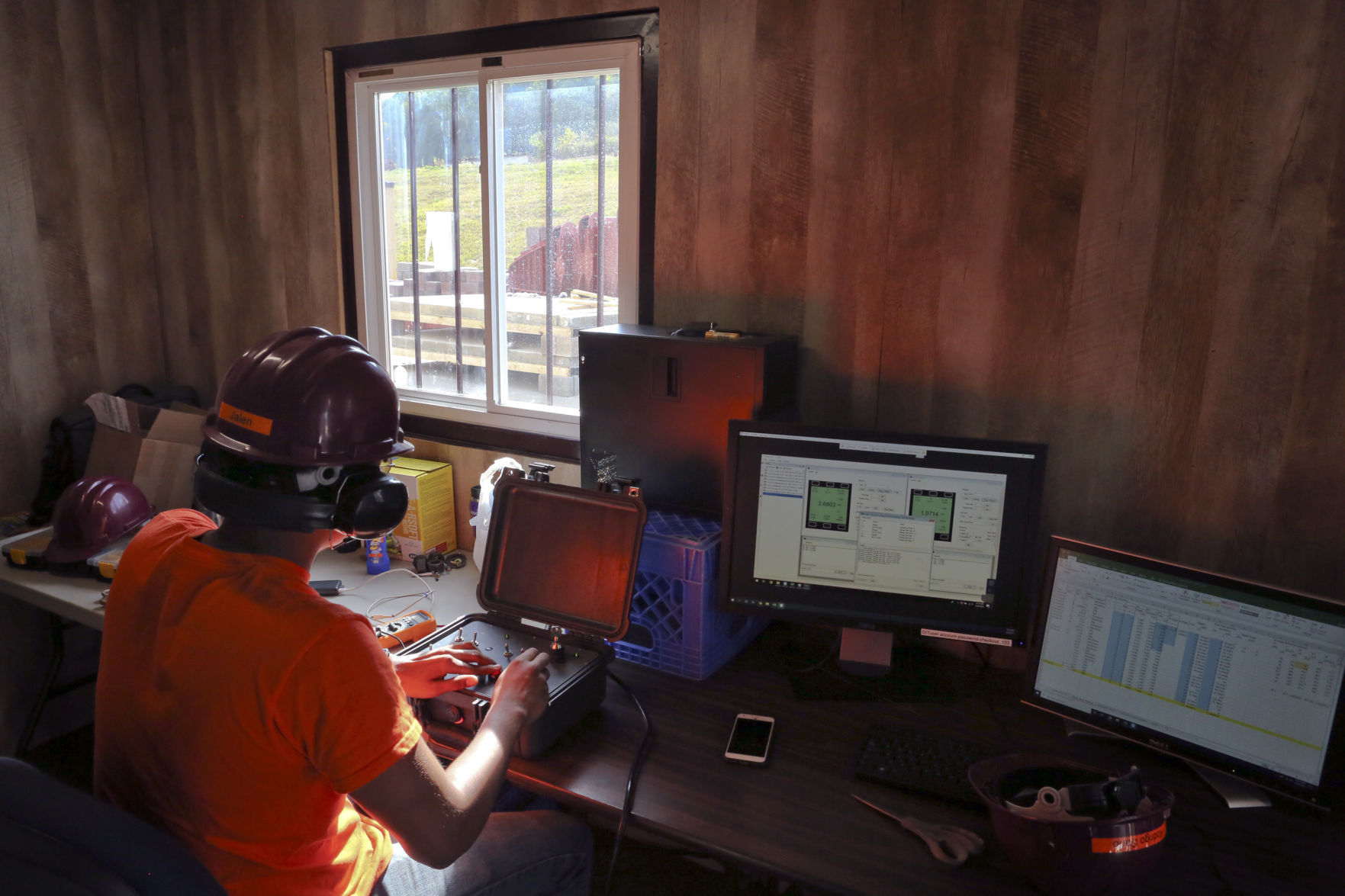 A graduate student fires the device from a nearby control room